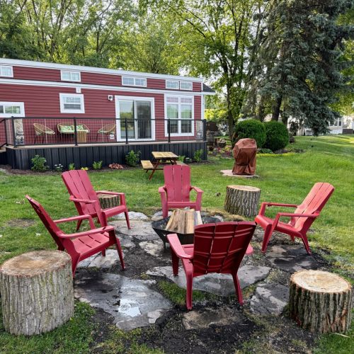 View of the fire pit area with the park model in the background.