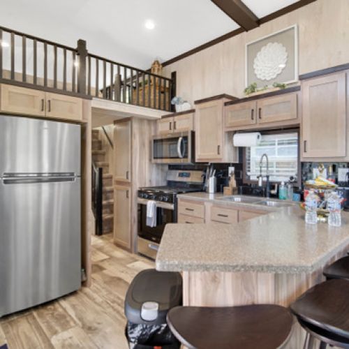 Well-appointed kitchen with a fridge, oven, & microwave making cooking easy and convenient.