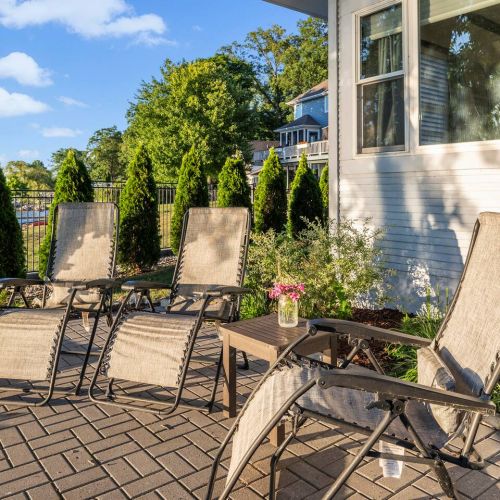 Outdoor chairs around fire pit overlooking the lake
