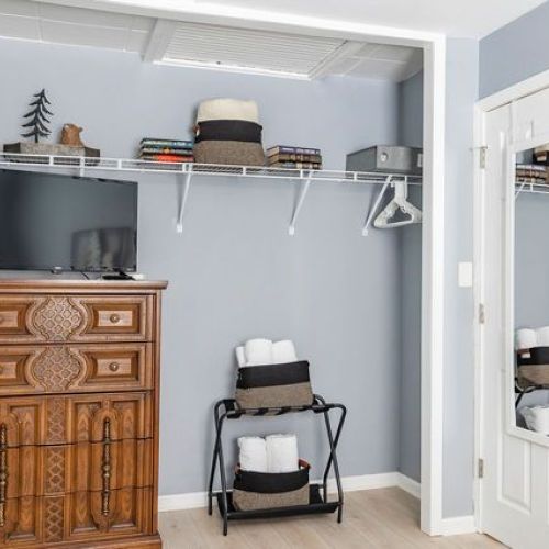 Bedroom closet area featuring a dresser and TV for added convenience and comfort.