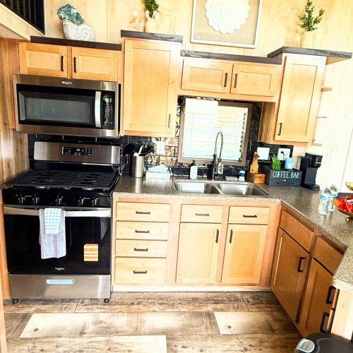 Another view of the kitchen highlighting the oven with a convenient microwave above.
