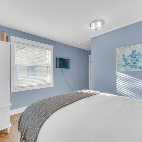 Primary Bedroom with Smart TV in view.