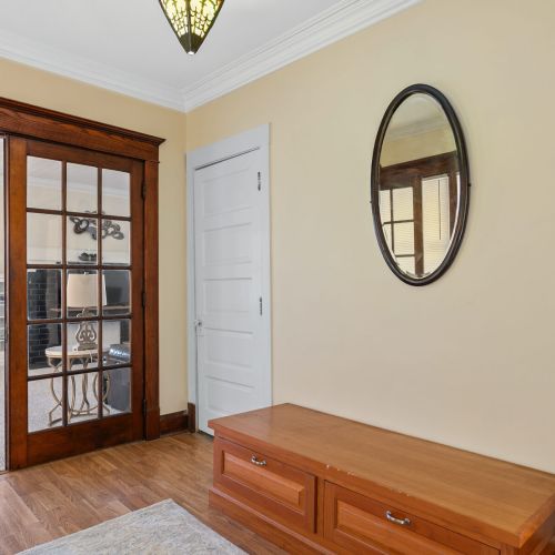 Front entrance with a bench, and doorway to the living room.