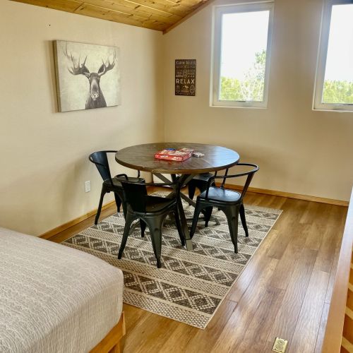 Loft with Queen bed, a portable closet & a table for 4