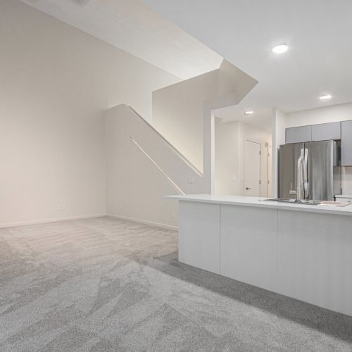 Living room view with hallway and stairwell.