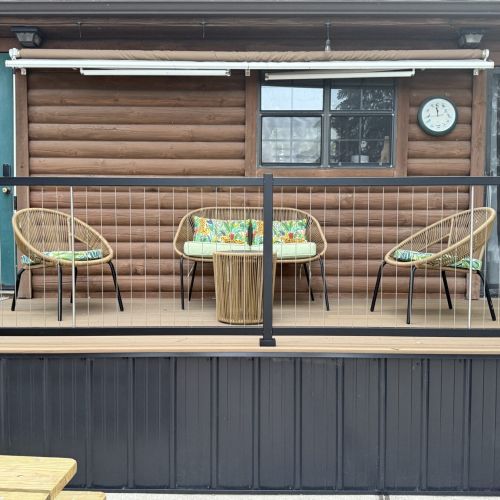 Cozy deck seating with a retractable awning, ideal for relaxing outside at any time of day.