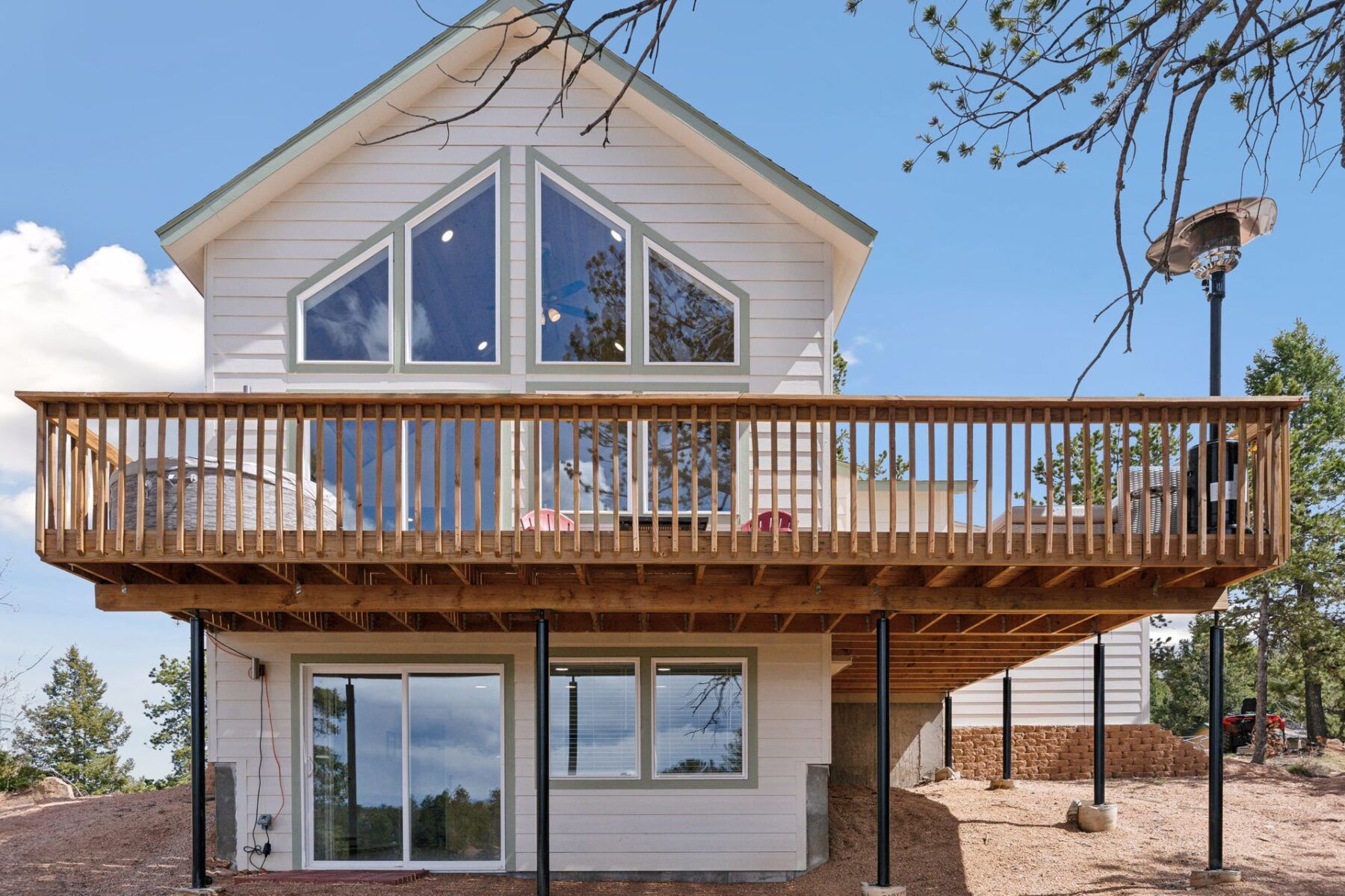 Rear deck with heater, fire pit, seating area and grill.