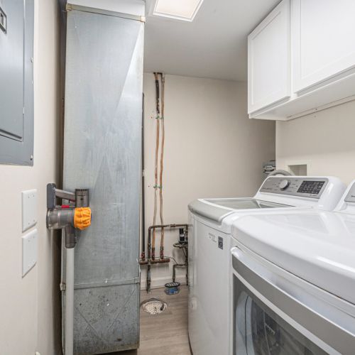 Laundry area equipped with a washer and dryer.