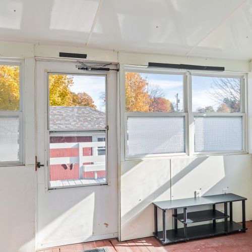Access the sunroom and back porch from the back entrance, perfect for enjoying fresh air and natural light.