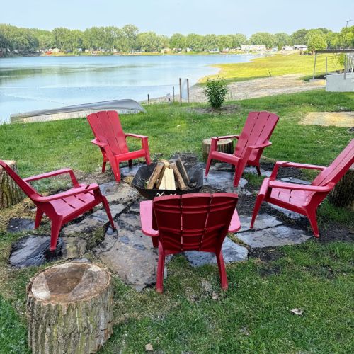 Relax by the fire pit just steps from the sandy beach and swimming area.