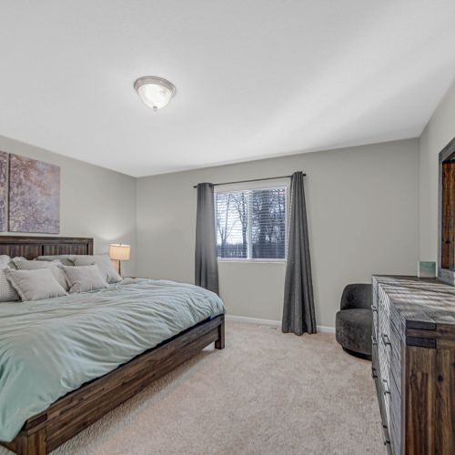 Spacious master bedroom with a comfortable king bed.