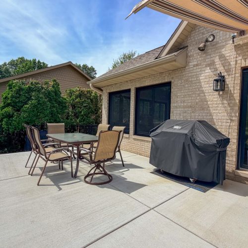 Enjoy outdoor dining on the patio with a grill and seating.