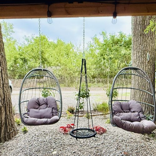 Fun outdoor seating with birdcage swings and a convenient on-site parking space.