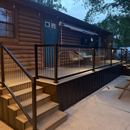 Cozy nighttime deck with lights highlighting pathways and seating areas for evening enjoyment.