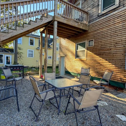 Outdoor seating area for the lower unit with chairs and a table.