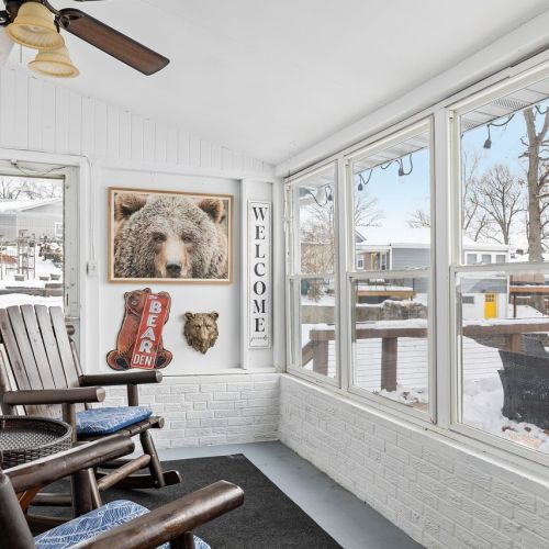 Relax in the sunny three-season room, perfect for enjoying the outdoors in comfort during spring, summer, and fall.