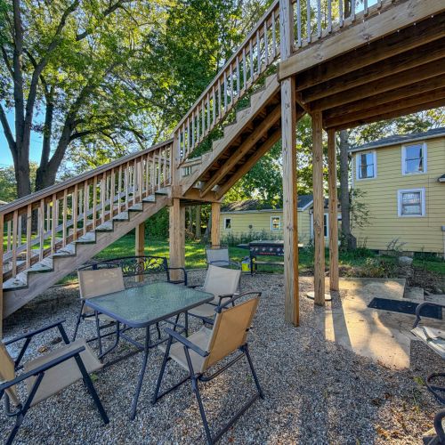 Outdoor seating area for the lower unit with chairs and a table.
