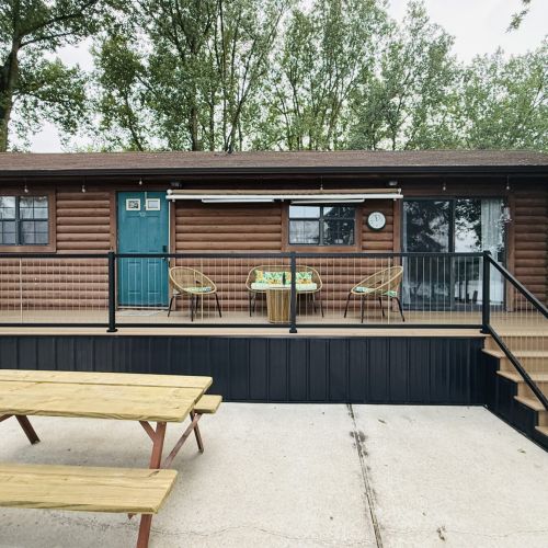 Funky Jungle - Wide deck perspective showing seating areas, front entrance, and sliding glass doors.