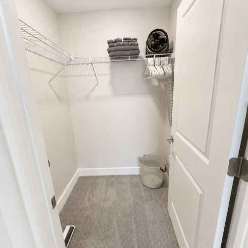 Walk in Closet with fan, hangers, laundry basket