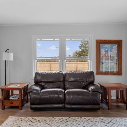 Family room overlooking backyard near kitchen and door leading to back porch. Fireplace not functional