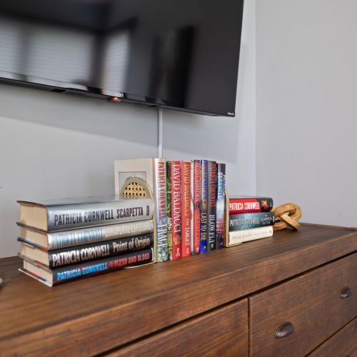 Bedroom 1 - TV and books on dresser.