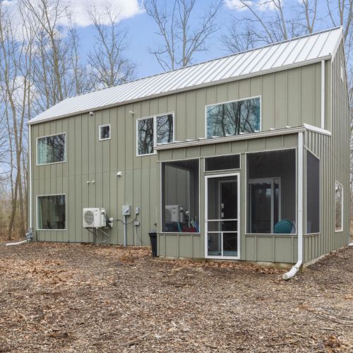 Back of the home with screened in porch.