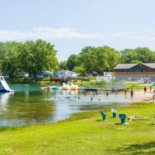Enjoy the lake at the campground with a water slide and paddle boats, perfect for summer fun.