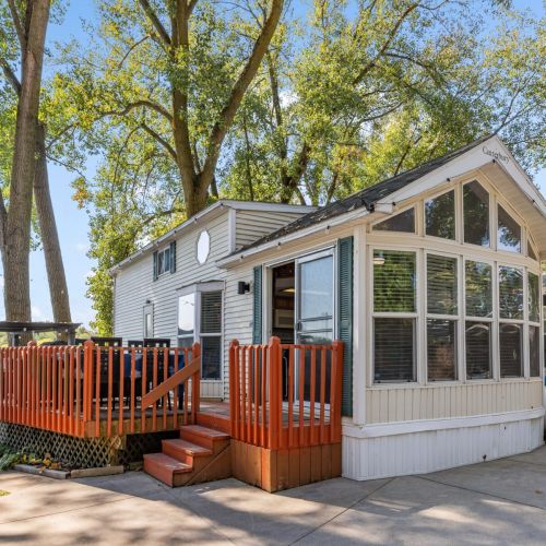 Charming view of the Funky Turtle park model, showcasing its cozy design and campground setting.