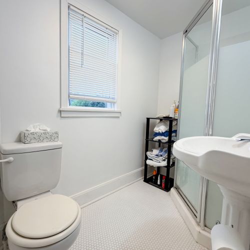 Clean and convenient bathroom featuring a walk-in shower.