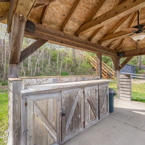 Covered Porch with Fireplace by Water View 2