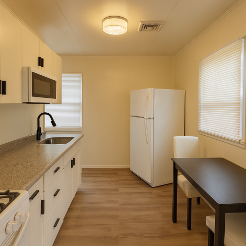 Kitchen with gas stove, full size refrigerator and microwave