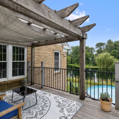 Deck with pond and pool view.