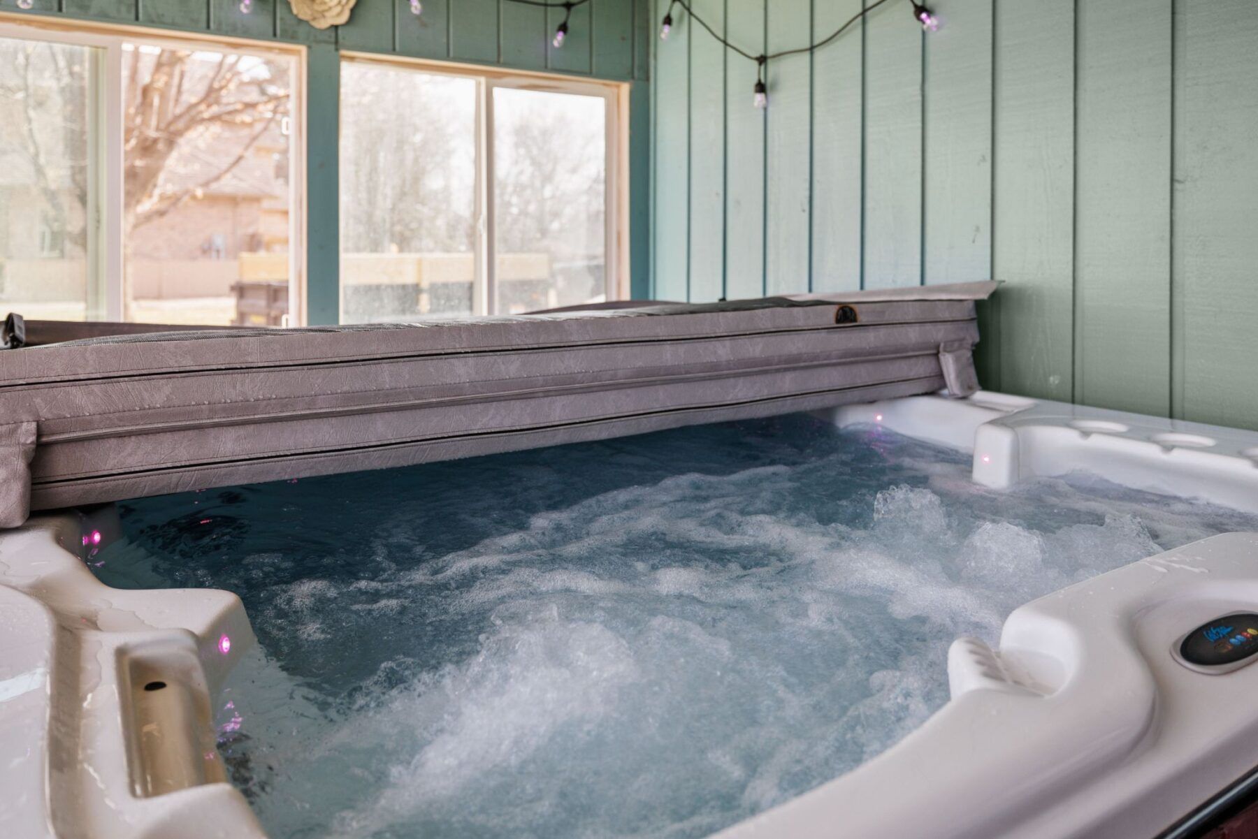 Hot tub for 5 people sits in enclosed porch