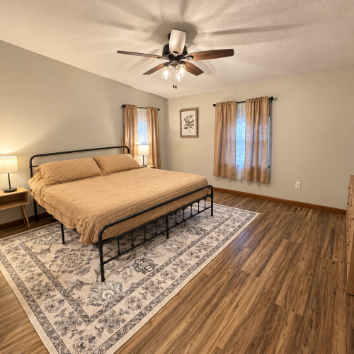 Additional view of the master bedroom, showcasing the king-size bed and room layout.