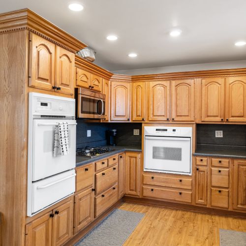 Spacious kitchen featuring natural wood cabinets, built-in oven, and ample prep space—perfect for family meals or group stays.