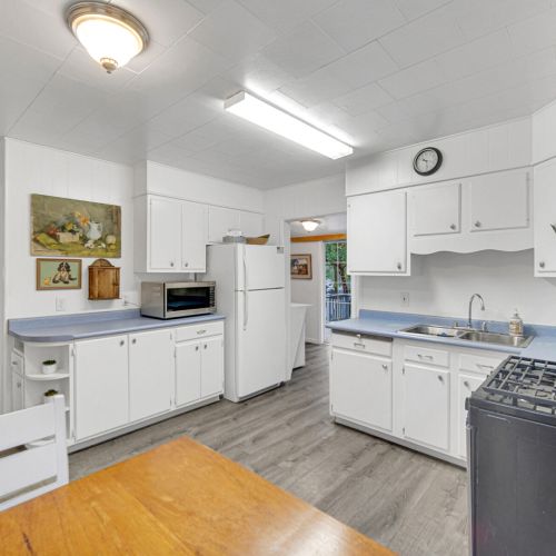 Kitchen view into the laundry area and one of the bedrooms.