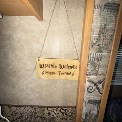 Charming welcome sign adding a magical touch as you enter the Funky Wizard travel trailer.