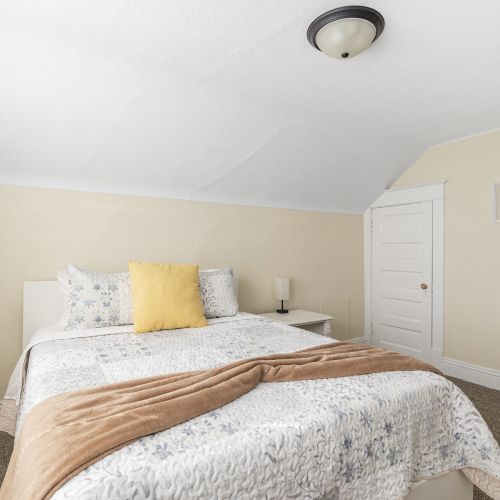 Spacious bedroom designed for comfort, featuring soft pillows, cozy accents, and a peaceful atmosphere.