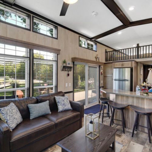 Living area with a couch and built-in bed, perfect for extra guests or lounging.
