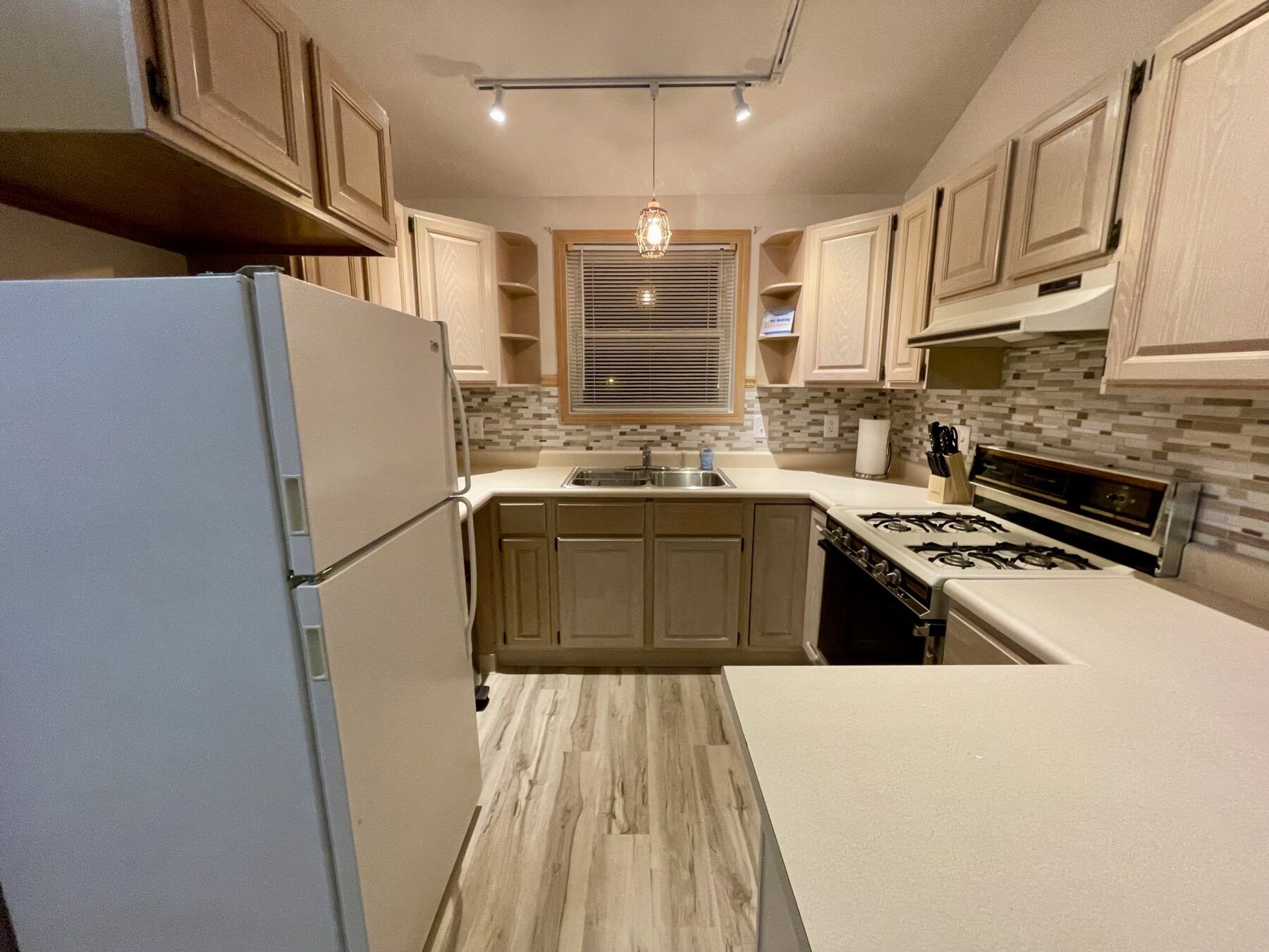 Kitchen with gas stove, refrigerator and microwave and Keurig