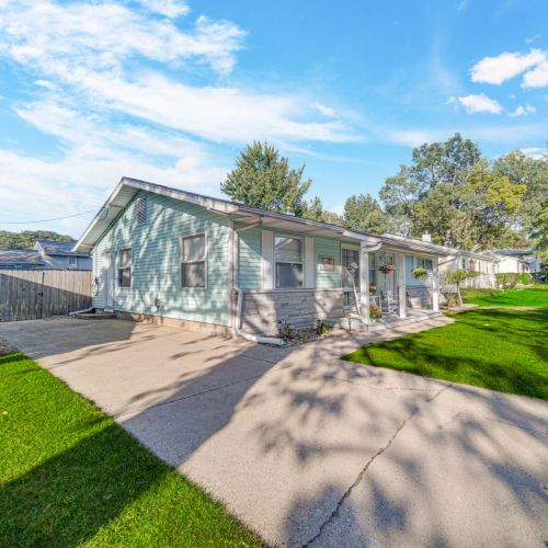 Side view of house and driveway, free parking, 3 cars can fit comfortably with extra parking on the street. EV charger for electric vehicles.