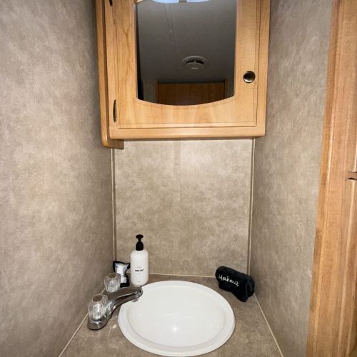 Functional bathroom sink area, perfect for your daily routines while staying in the travel trailer.