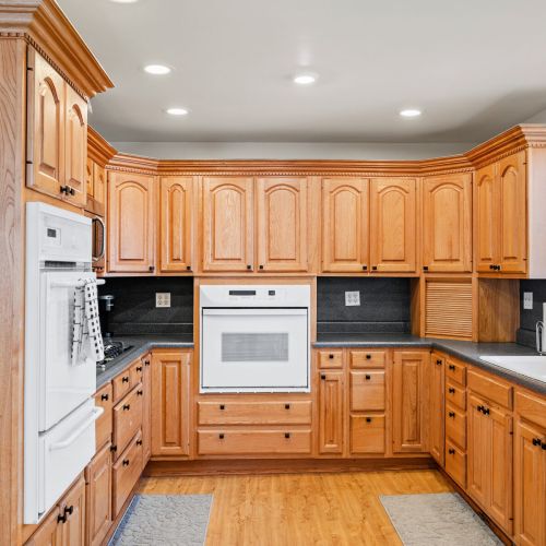 Spacious kitchen featuring natural wood cabinets, built-in oven, and ample prep space—perfect for family meals or group stays.