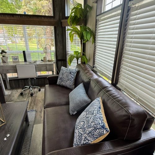 Living area with a couch and built-in bed, perfect for extra guests or lounging.