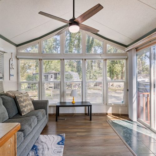 Living room with sliding glass door access, making it easy to step outside and enjoy the lake and campground surroundings.