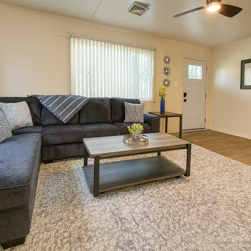 Living Room with Sectional Sofa, Ceiling Fan, side table, Smart TV & Coffee Table