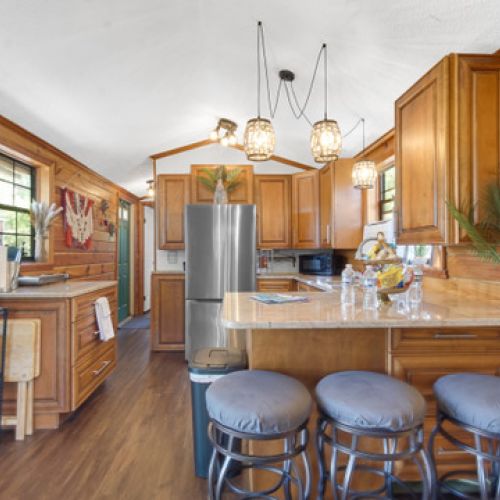 Kitchen with fridge, microwave, hot plate, and coffee maker.