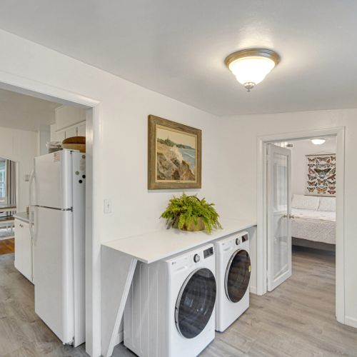 Laundry area, looking into the kitchen and one of the bedrooms.