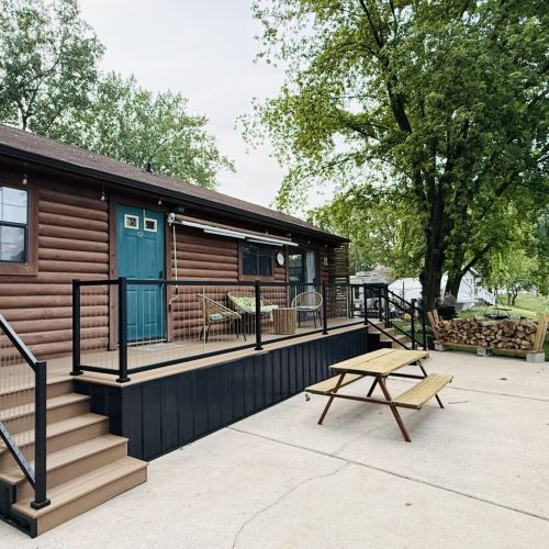 Outdoor deck overlooking the lake with a roll-out awning and cozy seating area.