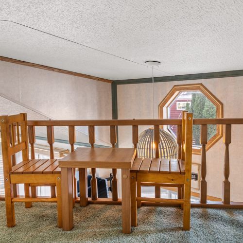 Close-up of the small loft table, overlooking the open living space below.